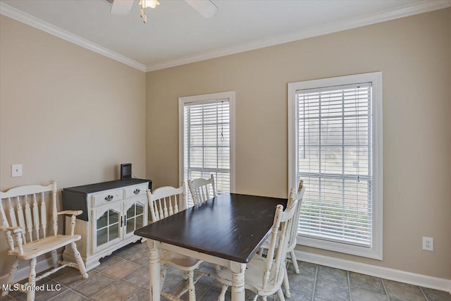 dining area featuring ornamental molding, a ceiling fan, and baseboards