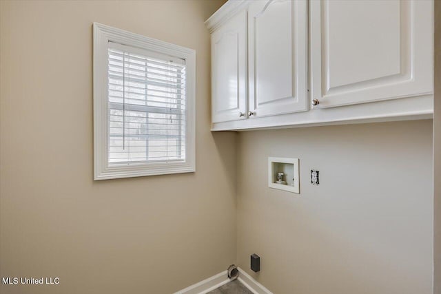 laundry room featuring hookup for a washing machine, cabinet space, and baseboards