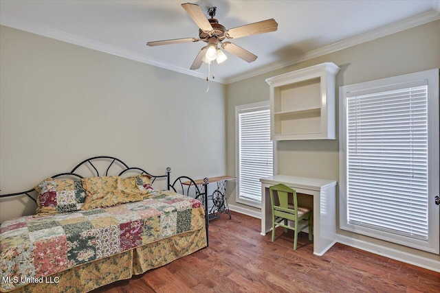 bedroom with a ceiling fan, crown molding, baseboards, and wood finished floors