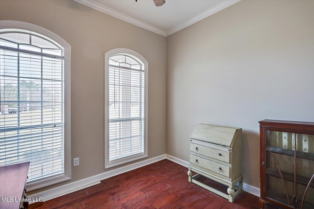 interior space with ornamental molding, wood finished floors, and baseboards