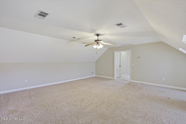 bonus room featuring light carpet, lofted ceiling, visible vents, and baseboards