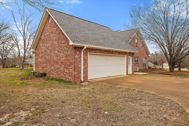 view of property exterior featuring concrete driveway, roof with shingles, an attached garage, a yard, and brick siding