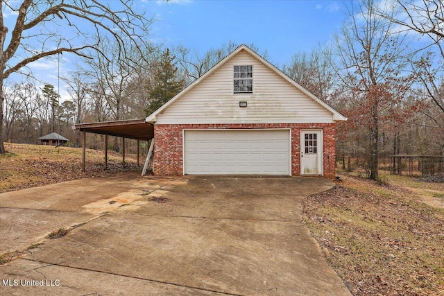 garage featuring concrete driveway