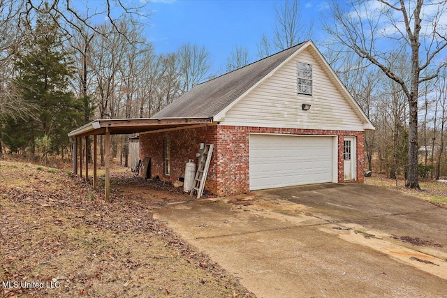 view of property exterior with a garage, driveway, and brick siding