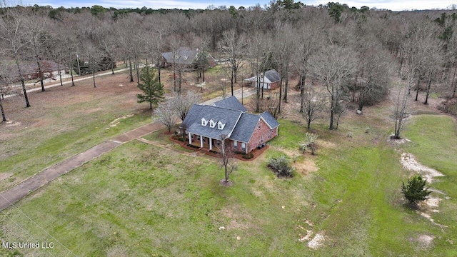 birds eye view of property with a forest view