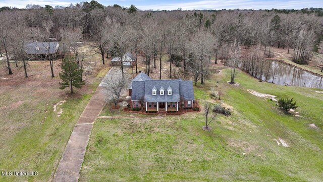 drone / aerial view with a water view and a wooded view