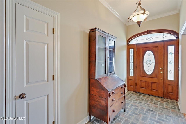 foyer entrance with brick floor and ornamental molding