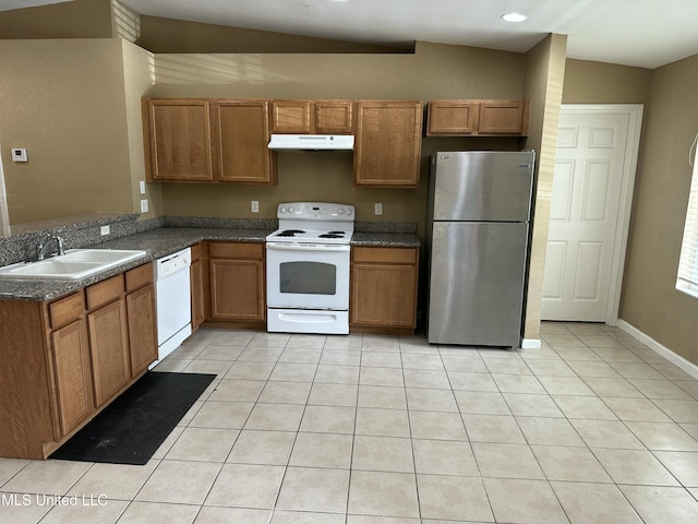 kitchen with sink, light tile patterned floors, white appliances, and kitchen peninsula