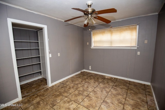 tiled empty room with ornamental molding and ceiling fan