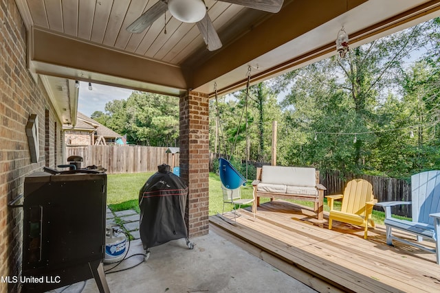 513 Willow Valley Cir, Brandon, MS 39047 - fenced backyard featuring ceiling fan, a deck, a grill, and view of scattered trees