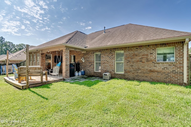 513 Willow Valley Cir, Brandon, MS 39047 - back of house featuring brick siding, roof with shingles, a lawn, and a wooden deck