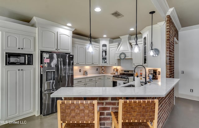 513 Willow Valley Cir, Brandon, MS 39047 - kitchen featuring stainless steel appliances, concrete floors, crown molding, backsplash, and a peninsula