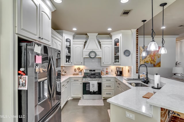 513 Willow Valley Cir, Brandon, MS 39047 - kitchen featuring stainless steel appliances, a peninsula, premium range hood, finished concrete floors, and decorative backsplash