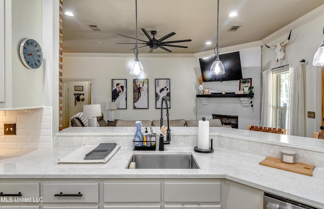 513 Willow Valley Cir, Brandon, MS 39047 - kitchen with a fireplace, a ceiling fan, open floor plan, white cabinetry, and light stone counters