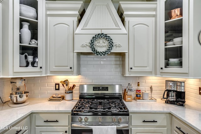 513 Willow Valley Cir, Brandon, MS 39047 - kitchen featuring gas range, white cabinetry, glass insert cabinets, and backsplash