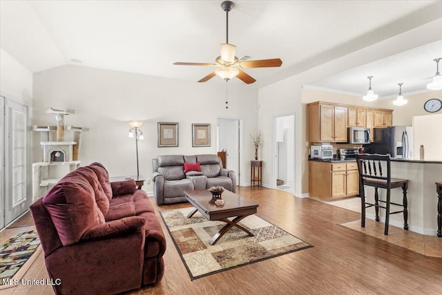 living room with ceiling fan, light wood-type flooring, and lofted ceiling