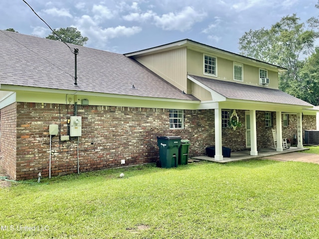 302 Mulberry Ln, Quitman, MS 39355 - view of side of property featuring roof with shingles, a lawn, brick siding, a patio, and cooling unit