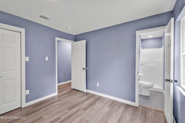 2713 Brazil St, Pascagoula, MS 39581 - unfurnished bedroom with connected bathroom, visible vents, wood finished floors, and baseboards