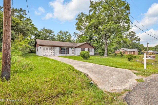 2713 Brazil St, Pascagoula, MS 39581 - view of front of property with a garage, a front yard, and driveway