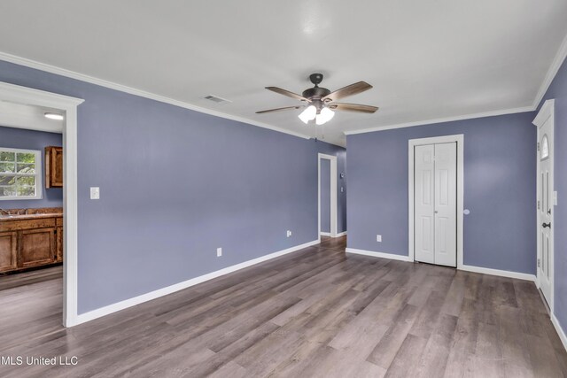 2713 Brazil St, Pascagoula, MS 39581 - unfurnished bedroom with crown molding and dark wood-style floors