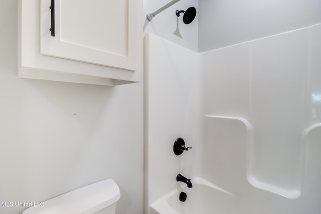 bathroom featuring shower / bath combination and toilet
