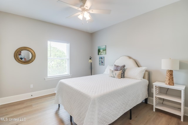 bedroom featuring baseboards, a ceiling fan, and light wood-type flooring
