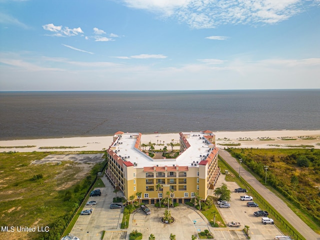 birds eye view of property with a water view and a beach view