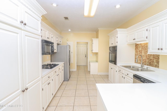 kitchen with crown molding, sink, white cabinets, and black appliances