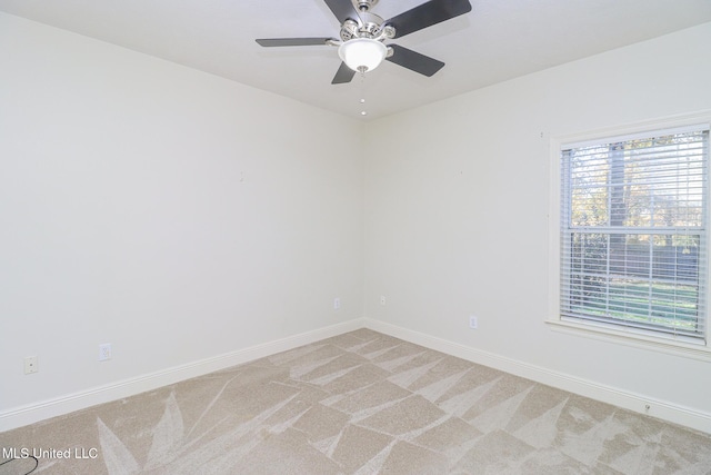 unfurnished room featuring plenty of natural light, ceiling fan, and light carpet