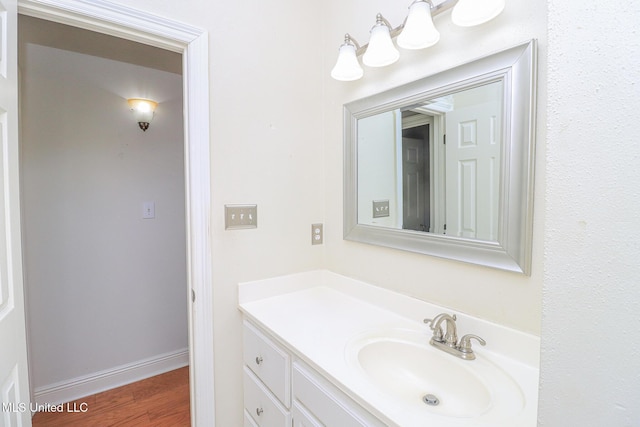 bathroom with hardwood / wood-style flooring and vanity