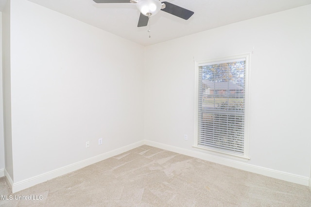 unfurnished room featuring ceiling fan and light carpet