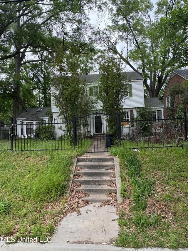 obstructed view of property featuring a front yard