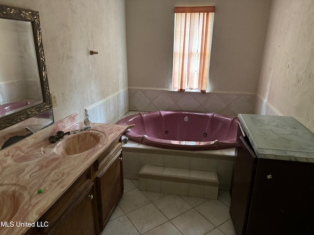 bathroom with vanity, tiled tub, and tile patterned floors