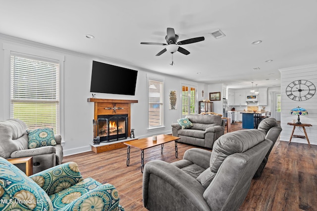 living room featuring ceiling fan, hardwood / wood-style floors, and plenty of natural light