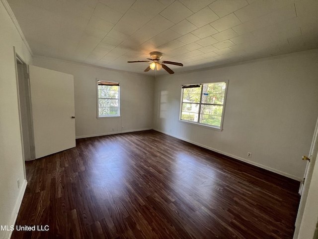 802 Farmer St, Cleveland, MS 38732 - empty room with dark wood-style flooring, a ceiling fan, baseboards, and crown molding
