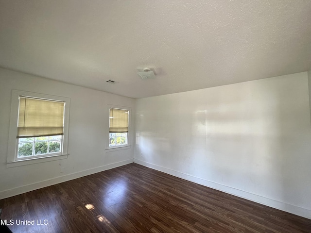 802 Farmer St, Cleveland, MS 38732 - unfurnished room with healthy amount of natural light, dark wood-type flooring, and baseboards