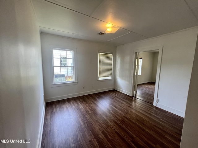 802 Farmer St, Cleveland, MS 38732 - unfurnished room with plenty of natural light, dark wood-style floors, and baseboards