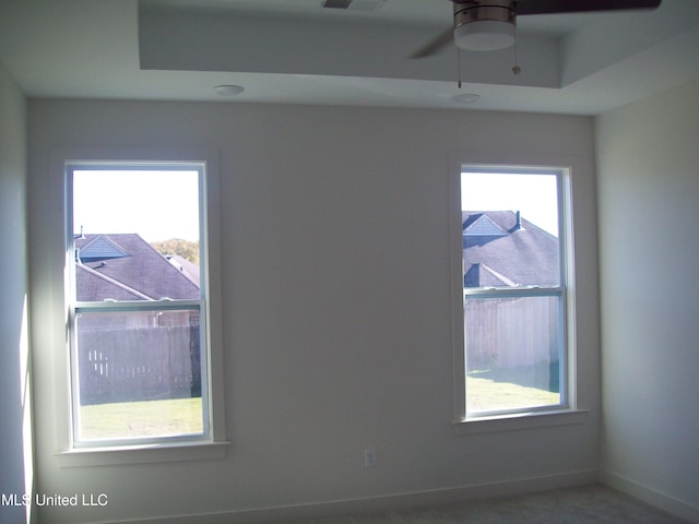 spare room featuring ceiling fan and a healthy amount of sunlight