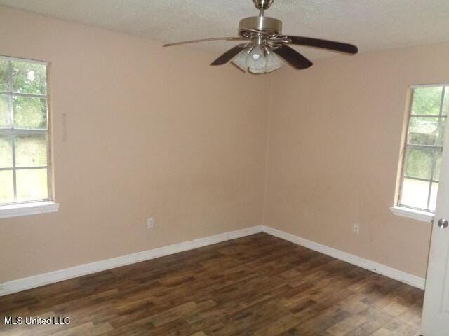 6301 Pioneer Trl, Moss Point, MS 39562 - spare room featuring dark wood finished floors, ceiling fan, and a textured ceiling