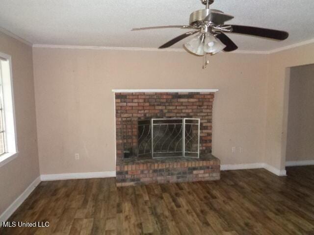 6301 Pioneer Trl, Moss Point, MS 39562 - unfurnished living room featuring wood finished floors, crown molding, ceiling fan, and a brick fireplace
