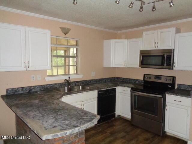 6301 Pioneer Trl, Moss Point, MS 39562 - kitchen with appliances with stainless steel finishes, a textured ceiling, white cabinets, ornamental molding, and dark wood-style floors
