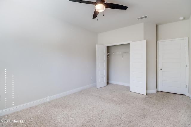 unfurnished bedroom with light carpet, a closet, and ceiling fan