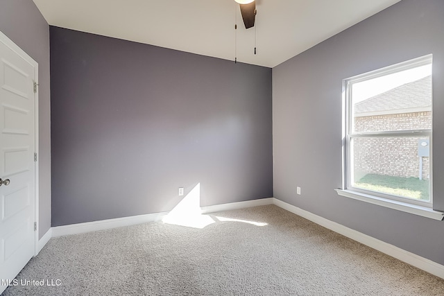 carpeted spare room featuring ceiling fan