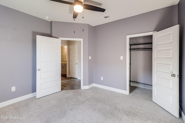 unfurnished bedroom featuring a closet and light colored carpet