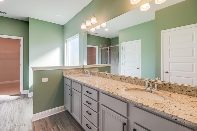 bathroom featuring vanity, walk in shower, and hardwood / wood-style floors