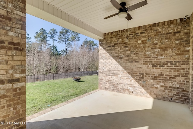 view of patio / terrace with a fire pit and ceiling fan