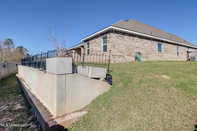 view of side of property with a lawn