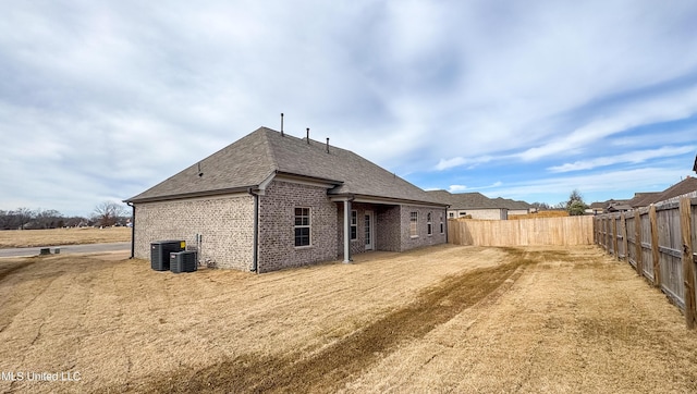 rear view of property featuring central air condition unit