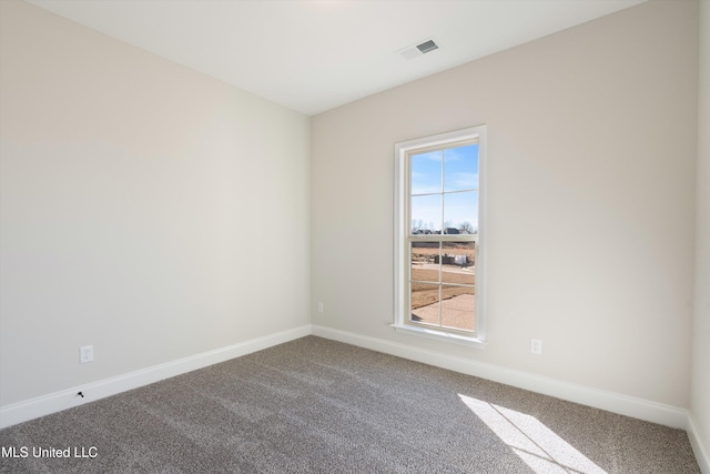 carpeted empty room with visible vents and baseboards