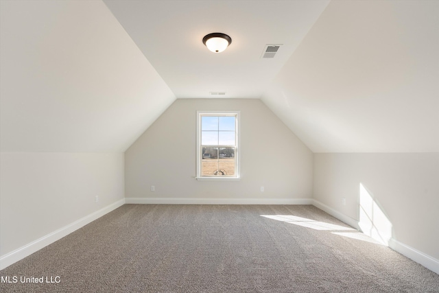 bonus room featuring lofted ceiling, baseboards, visible vents, and carpet flooring